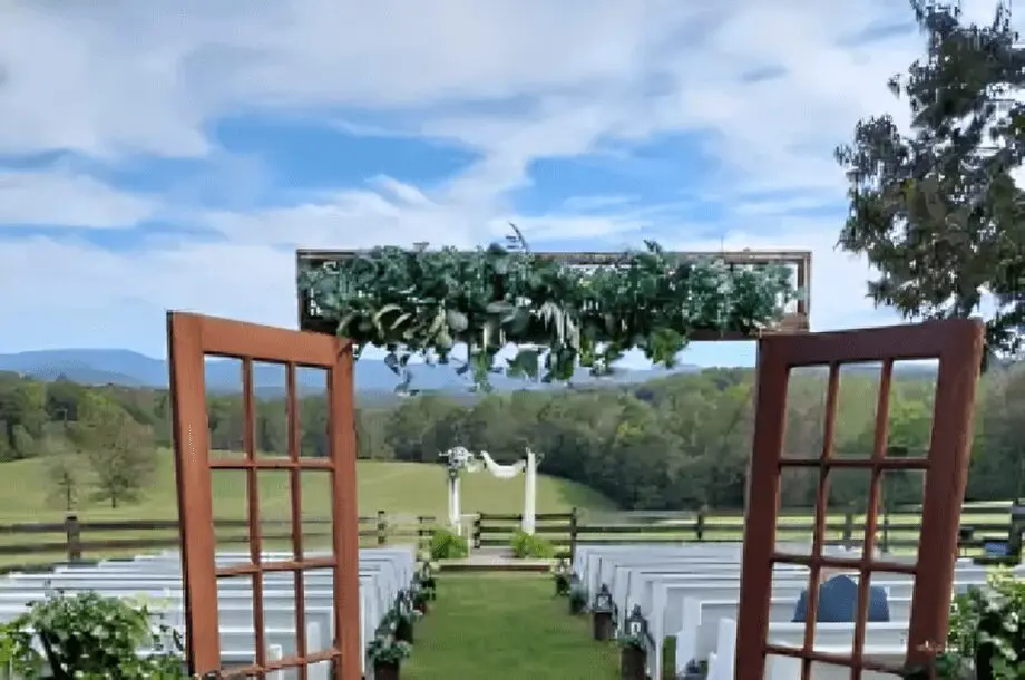Outdoor wedding ceremony setup with open doors.