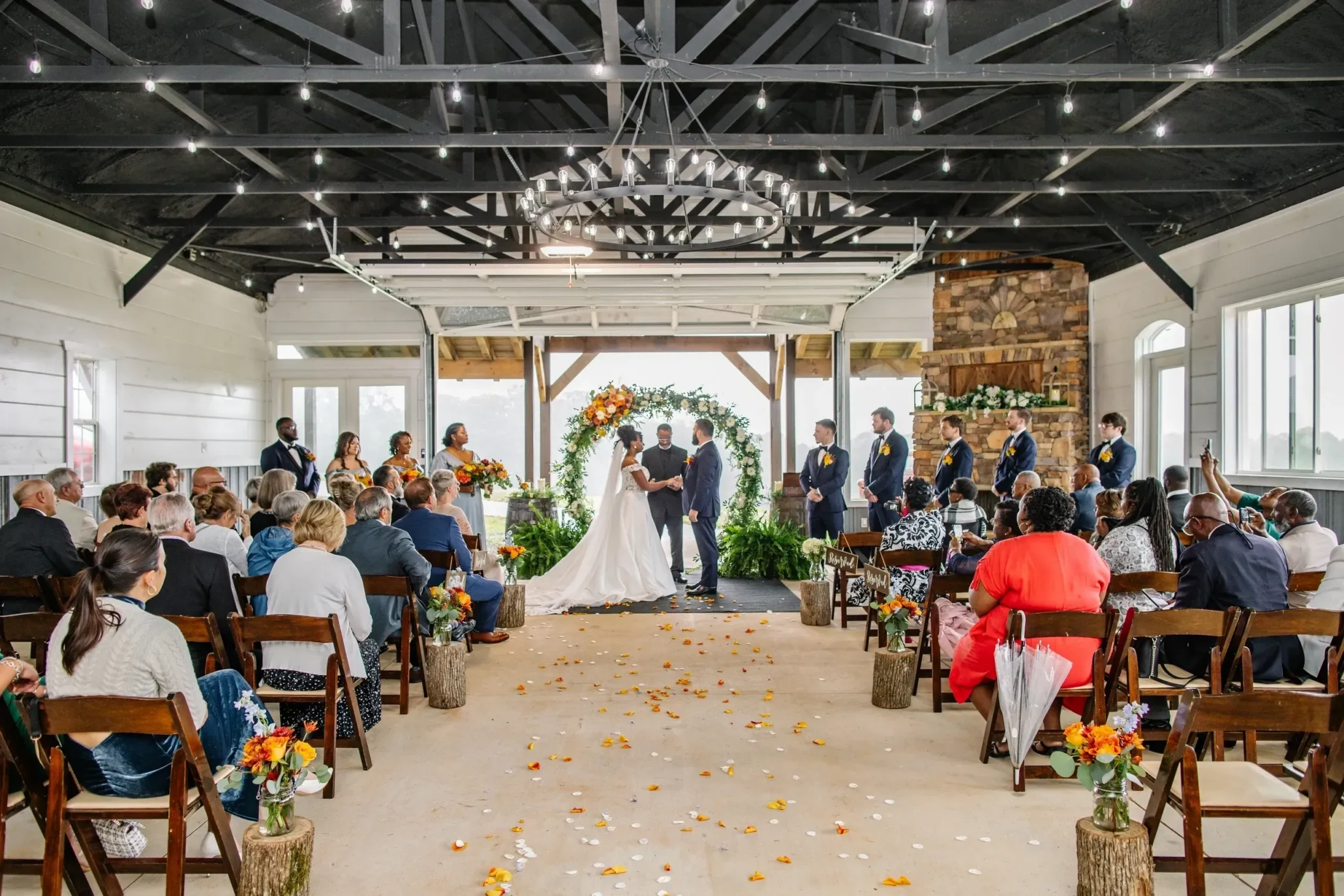 Wide view of rustic indoor wedding ceremony